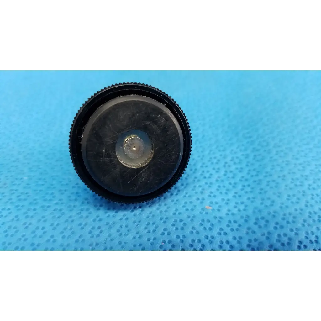 Black rubberized mechanical leveling screw foot with textured ridged edge and central metallic screw for threaded bolt use