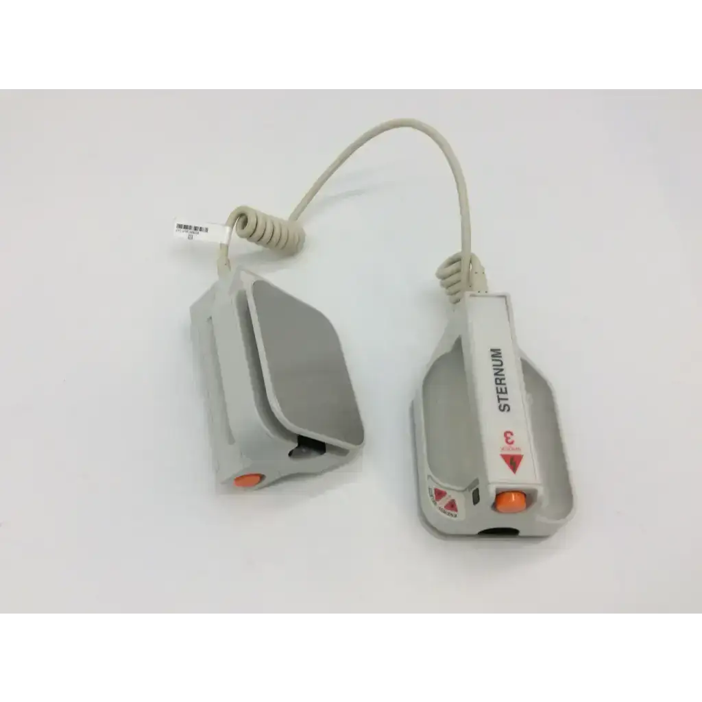 Gray plastic external paddle assembly with orange buttons and coiled cord labeled sternum for zoll defibrillators