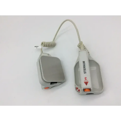 Gray plastic external paddle assembly with orange button coiled cable branded sternum for ZOLL defibrillators