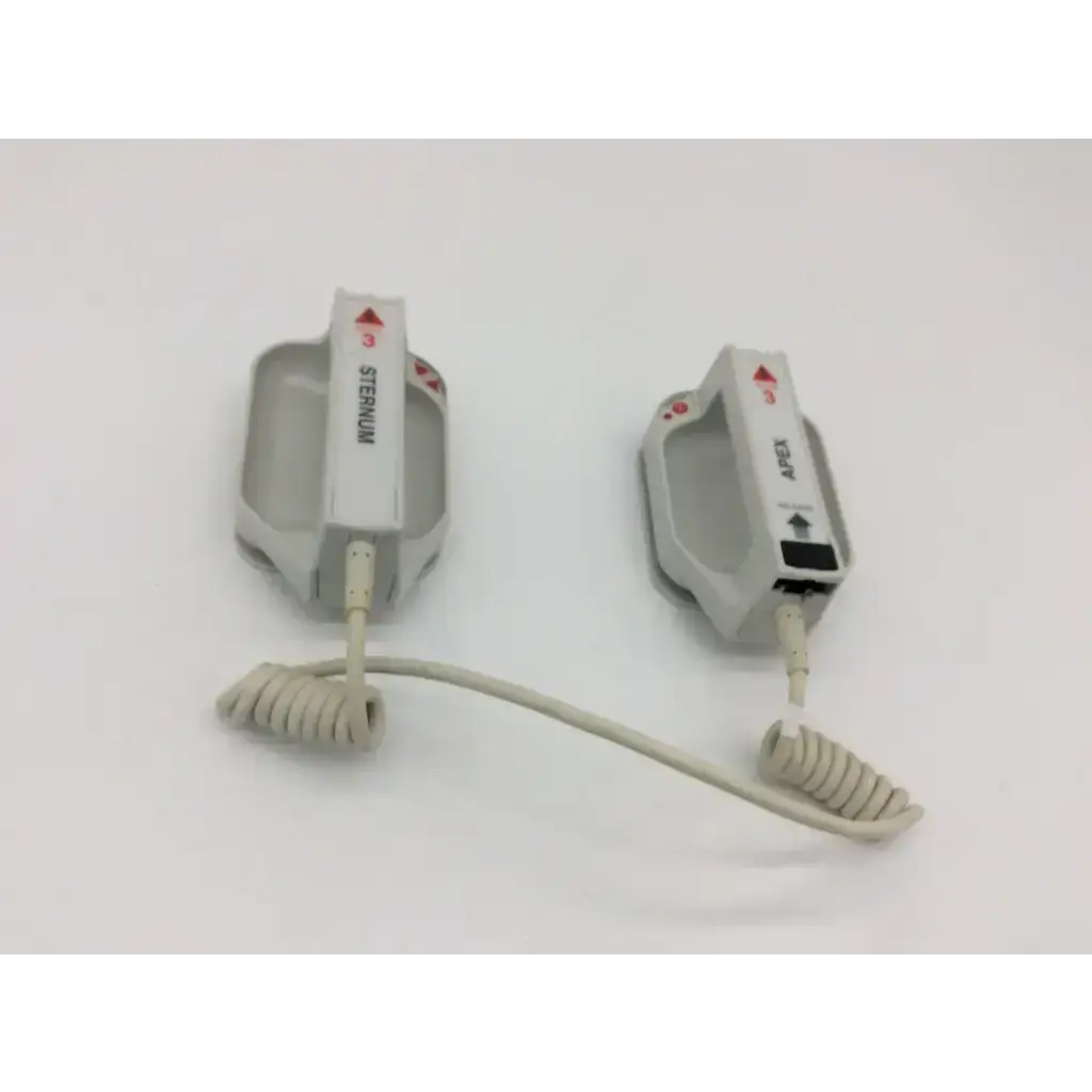 Two white external paddle assembly defibrillator pads with coiled cables labeled sternum and axis for medical emergency use