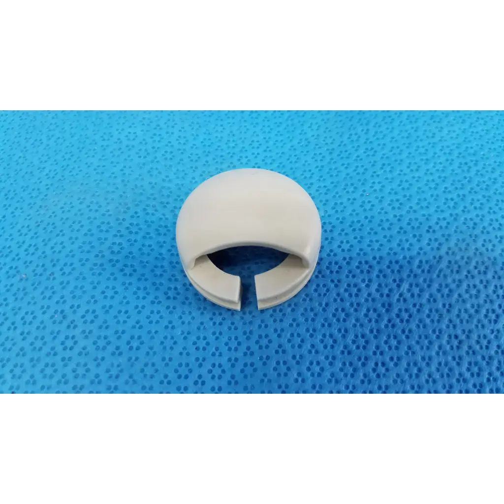 Off-white plastic mechanical neck base collar ring with smooth rounded exterior and split opening for joystick mechanical neck