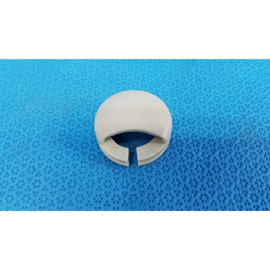 Off-white plastic mechanical neck base collar ring with smooth rounded exterior and split opening for joystick mechanical neck