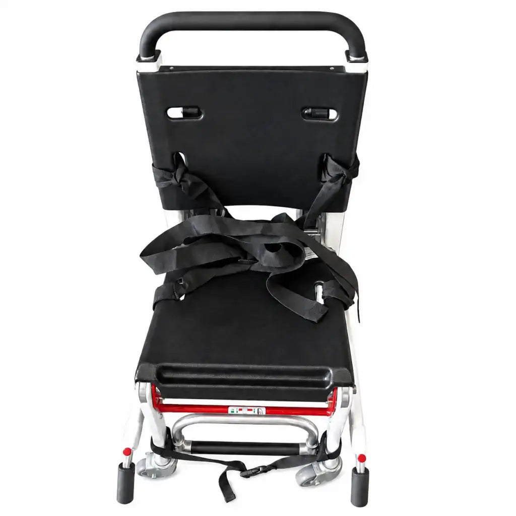 Black padded seat and backrest with adjustable straps on lightweight aluminum frame with red accents and caster wheels for ferno 59-e ez-glide evacuation chair