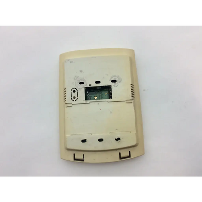 Beige plastic thermostat cover with internal circuit board and mounting holes shown from the back for wayne alarm systems