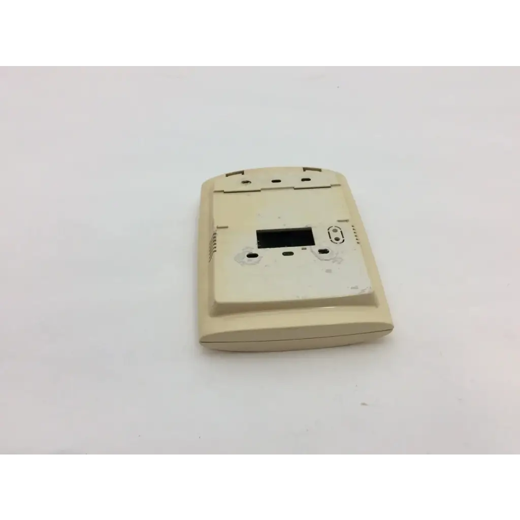 Beige plastic thermostat housing with rectangular digital display opening and ventilation slots for wayne alarm systems