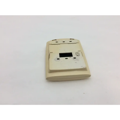 Beige plastic thermostat housing with rectangular digital display opening and ventilation slots for wayne alarm systems
