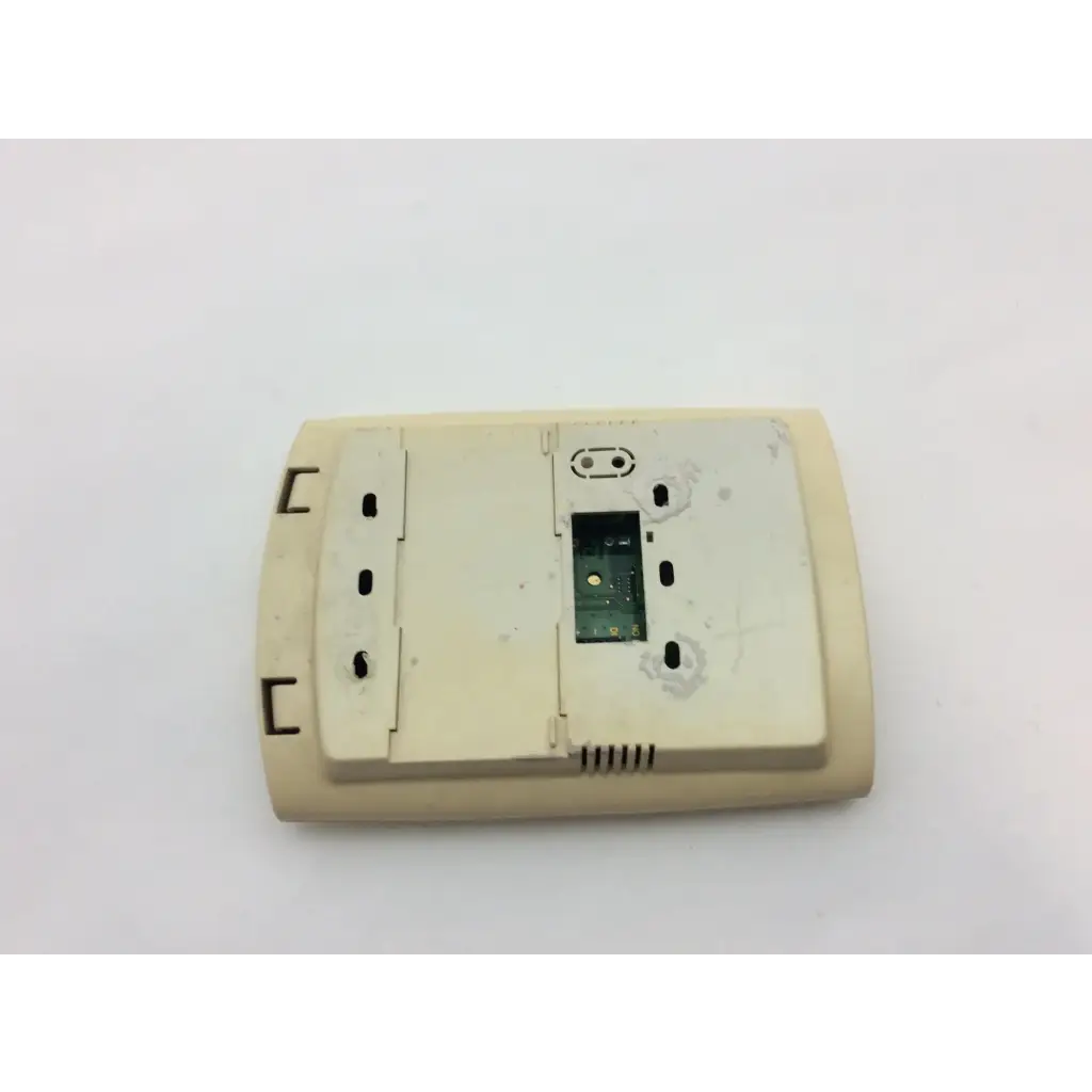 Beige plastic first fa260 thermostat showing internal circuit board and mounting holes for wayne alarm systems
