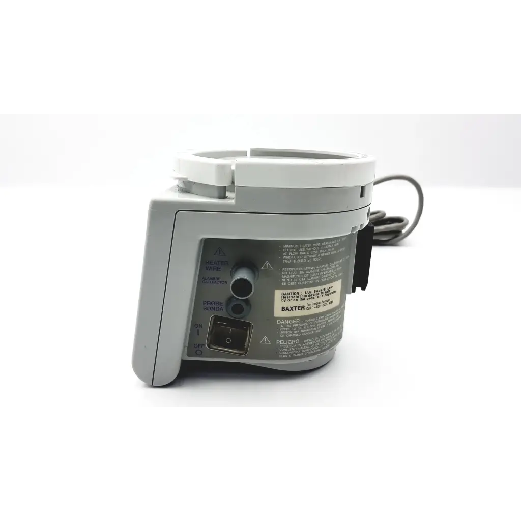 Gray plastic Fisher & Paykel humidifier MR730 with white circular top and black coiled cable featuring Baxter label