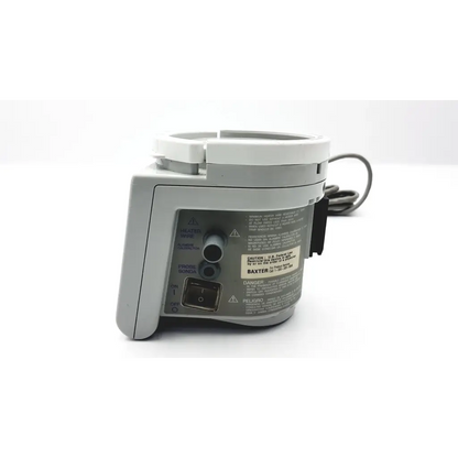 Gray plastic Fisher & Paykel humidifier MR730 with white circular top and black coiled cable featuring Baxter label