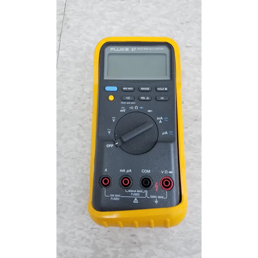 Yellow-cased fluke 87 true rms digital handheld multimeter with black front panel and multiple function buttons