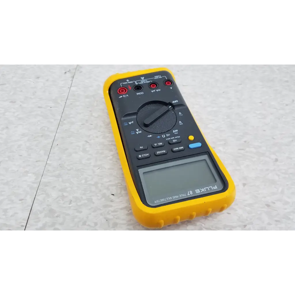Yellow and black fluke 87 true rms digital handheld multimeter with rotary dial digital display and multiple input jacks