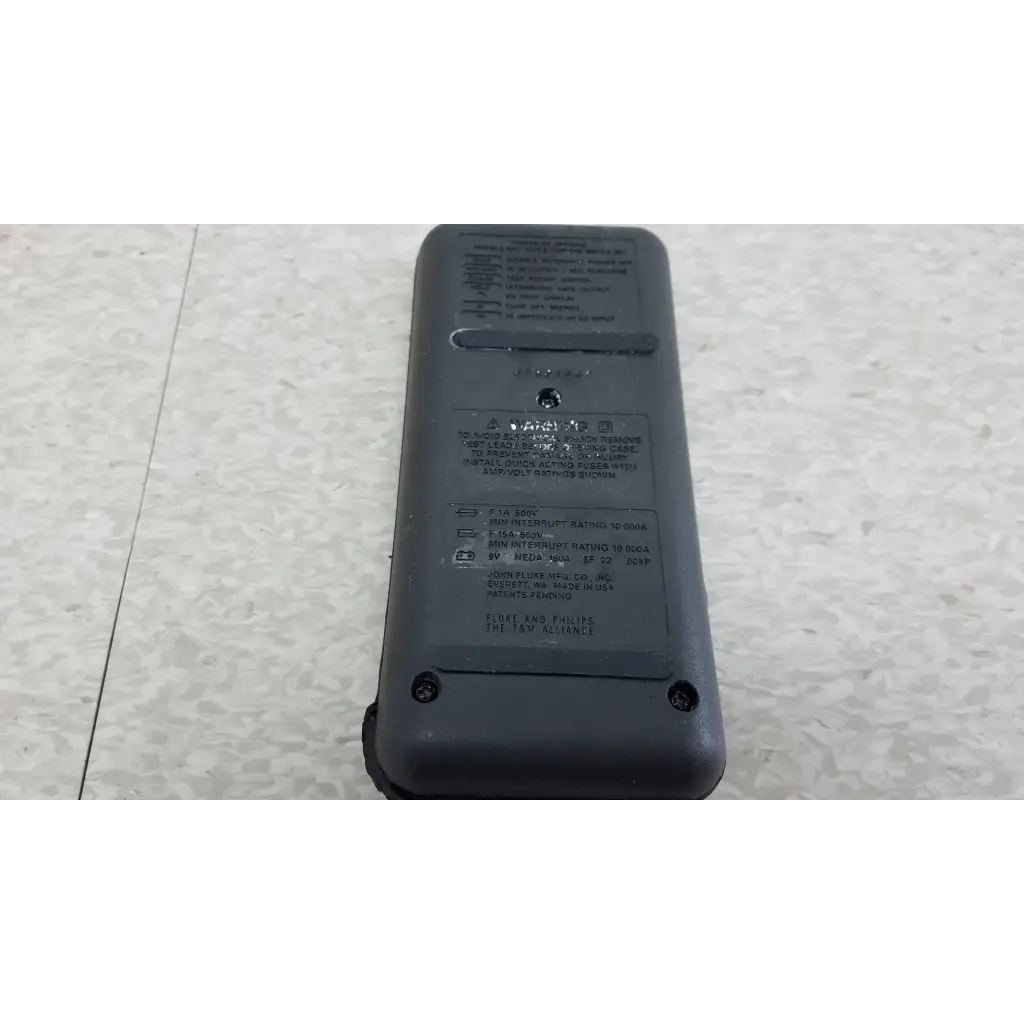 Gray plastic fluke 87 true rms digital handheld multimeter with black labeling and a small circular hole near the top