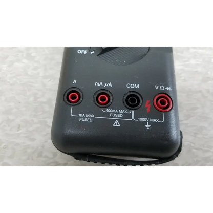 Black fluke 87 true rms digital handheld multimeter with red and black test leads ports for electrical measurements
