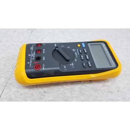 Yellow and black fluke 87 true rms digital handheld multimeter with red test probes for accurate electrical measurements