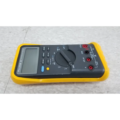 Fluke 87 true rms digital handheld multimeter in yellow and black with rotary dial and red and black test leads