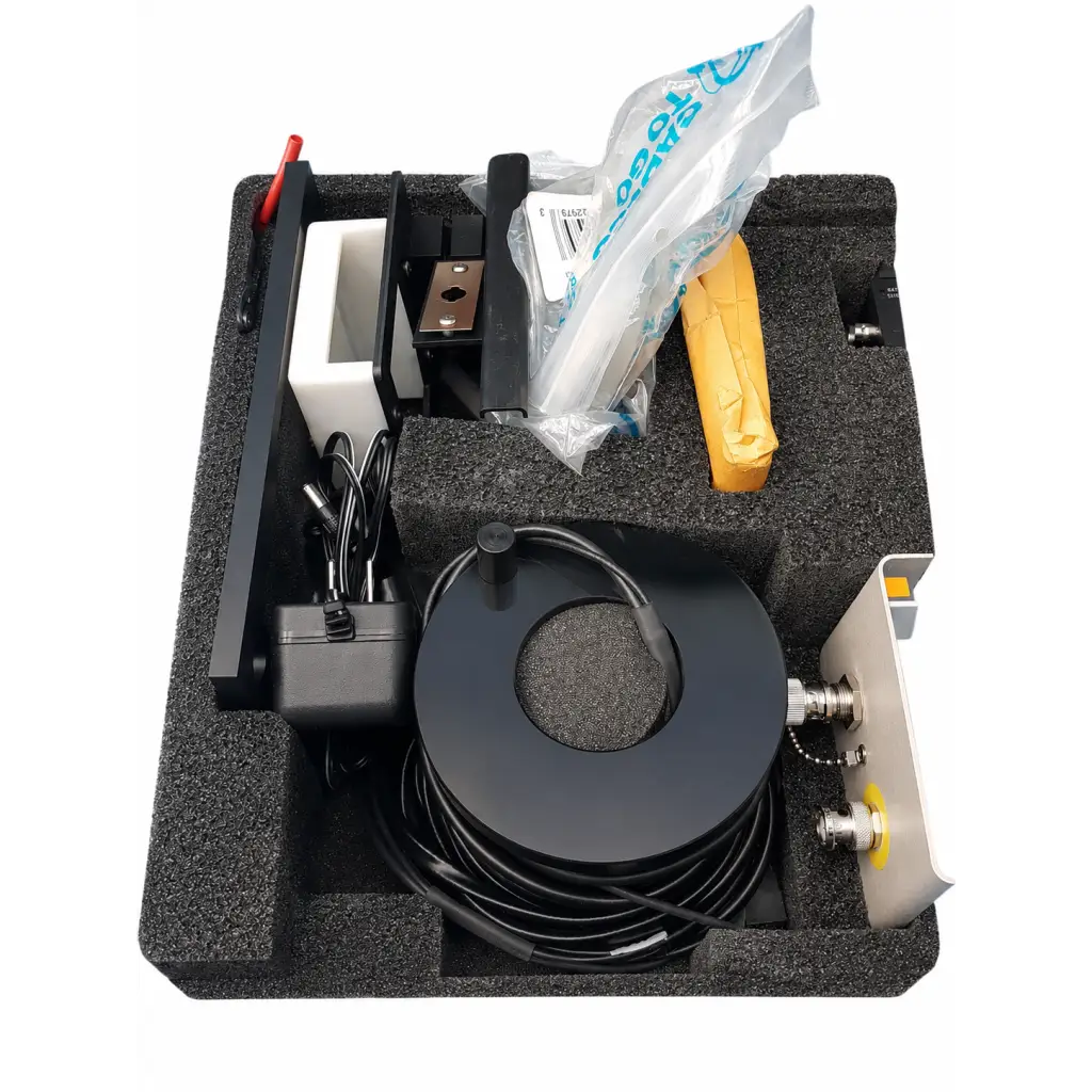 Black coiled cable with metallic connectors on circular spool for fluke biomedical triad tnt field service kit use