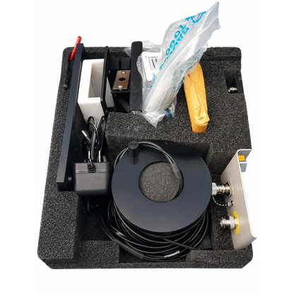 Black coiled cable with metallic connectors on circular spool for fluke biomedical triad tnt field service kit use