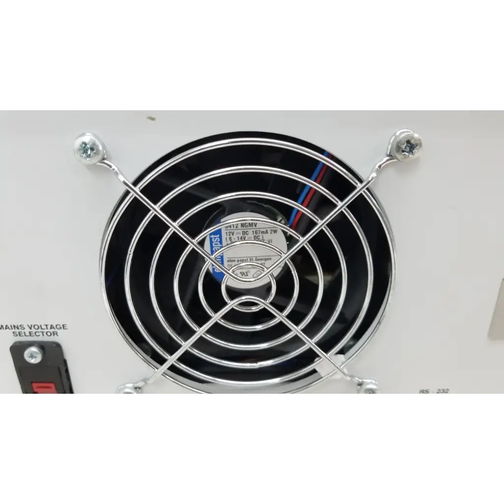 Black circular fan with chrome grille and wiring on the back of fluke biomedical qa-esii electrosurgery analyzer