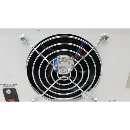 Black circular fan with chrome grille and wiring on the back of fluke biomedical qa-esii electrosurgery analyzer
