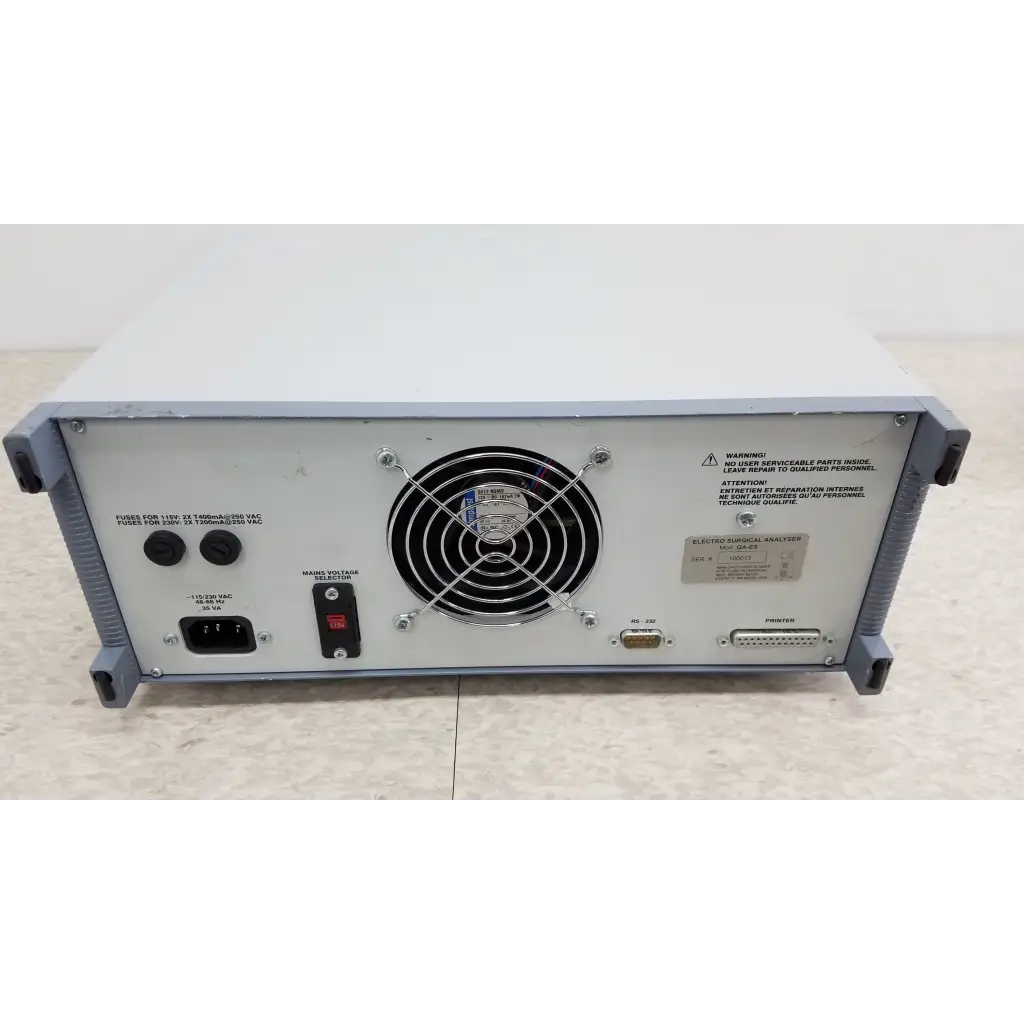 Backside of gray metal fluke biomedical qa-esii electrosurgery analyzer with circular fan grille and multiple ports