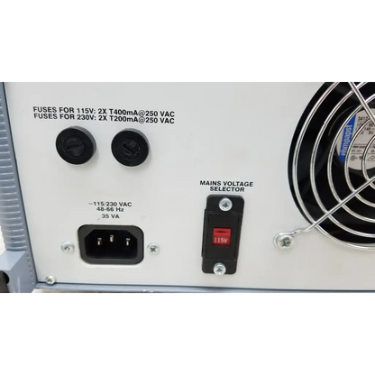 White power supply unit with black circular fuses red voltage selector and cooling fan on right side of fluke biomedical qa-esii electrosurgery analyzer