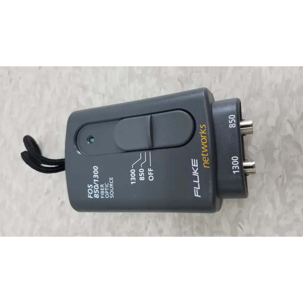 Black plastic fluke networks fos 850 1300 fiber optic source with two bnc connectors and toggle switch in cables case