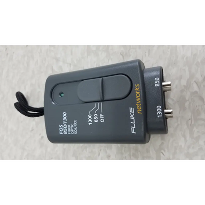 Black plastic fluke networks fos 850 1300 fiber optic source with two bnc connectors and toggle switch in cables case