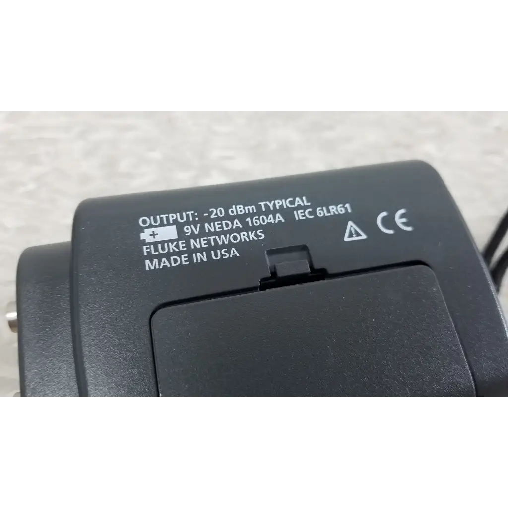 Black plastic fluke networks fiber optic source network tester with white printed specifications and certification marks