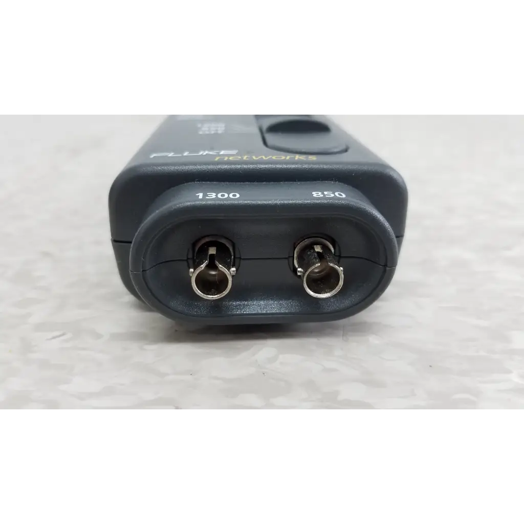 Black fluke networks 1300 fiber optic source with metallic connectors labeled 1300 and 850 nm included cables and case