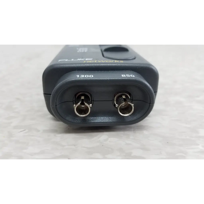 Black fluke networks 1300 fiber optic source with metallic connectors labeled 1300 and 850 nm included cables and case