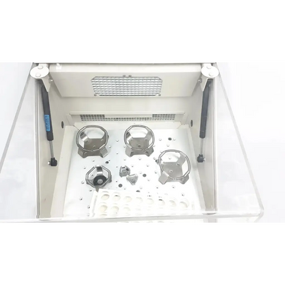 Silver metallic hexagonal and circular components inside a white lab hood for forma scientific orbital shaker 4518