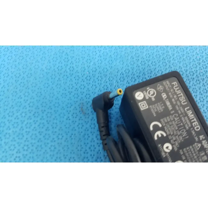 Black plastic fujitsu ac adapter power supply 19v 3.16a with coiled cord and yellow-tipped angled connector
