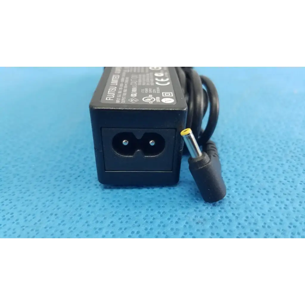 Black plastic fujitsu ac adapter power supply 19v 3.16a with coiled cord and yellow tip connector for laptop use
