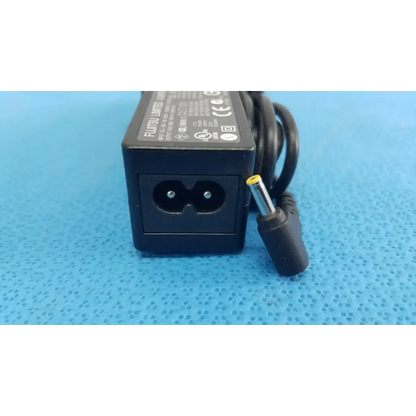 Black plastic fujitsu ac adapter power supply 19v 3.16a with coiled cord and yellow tip connector for laptop use