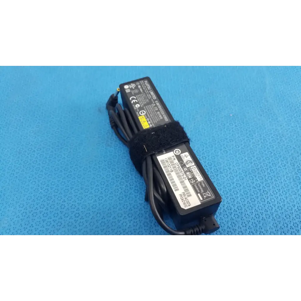Black plastic fujitsu ac adapter power supply 19v 3.16a with coiled cable and velcro strap for laptop use
