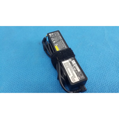 Black plastic fujitsu ac adapter power supply 19v 3.16a with coiled cable and velcro strap for laptop use