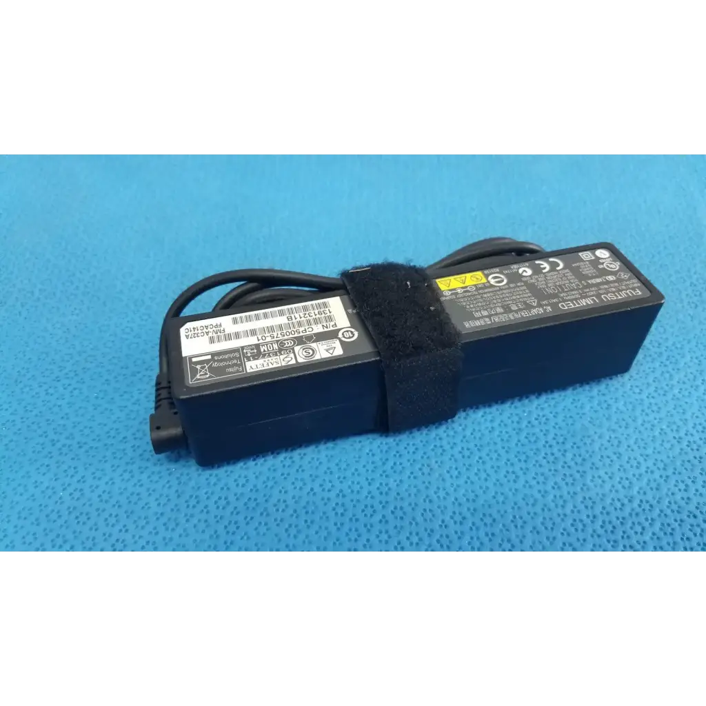 Black fujitsu ac adapter power supply 19v 3.16a with coiled cable secured by black velcro strap for laptop use