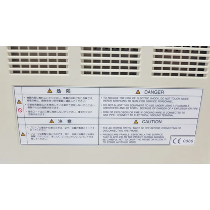 White plastic warning label with black text and yellow hazard symbols on the back of fukuda denshi uf-750xt portable ultrasound system