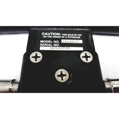 Black plastic Furniss Corporation Phoenix 1850 knee CPM device with silver screws and physician order caution label visible