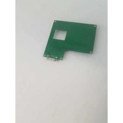 Green rectangular fw15lxg circuit board with square cutout and metallic connector at one corner for electronic use