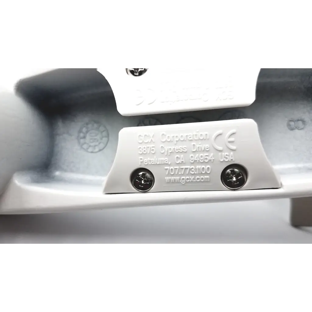 White plastic label with engraved scx corporation logo and contact info on the back of gcx wmm-0006-01 pivot arm