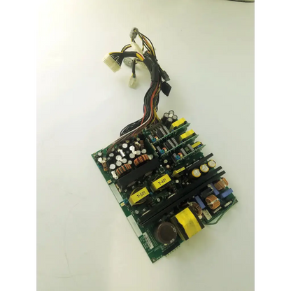 Green printed circuit board with black and yellow capacitors copper windings and connectors in healthcare aps400w ultrasound board