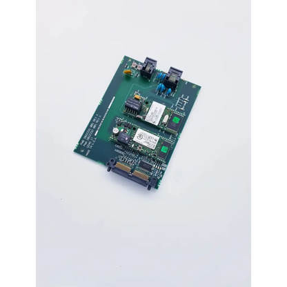 Green circuit board with black and blue connectors, integrated chips, and white labels for ge mac 5500 internal modem comm board with spacelabs mpc860 cpu