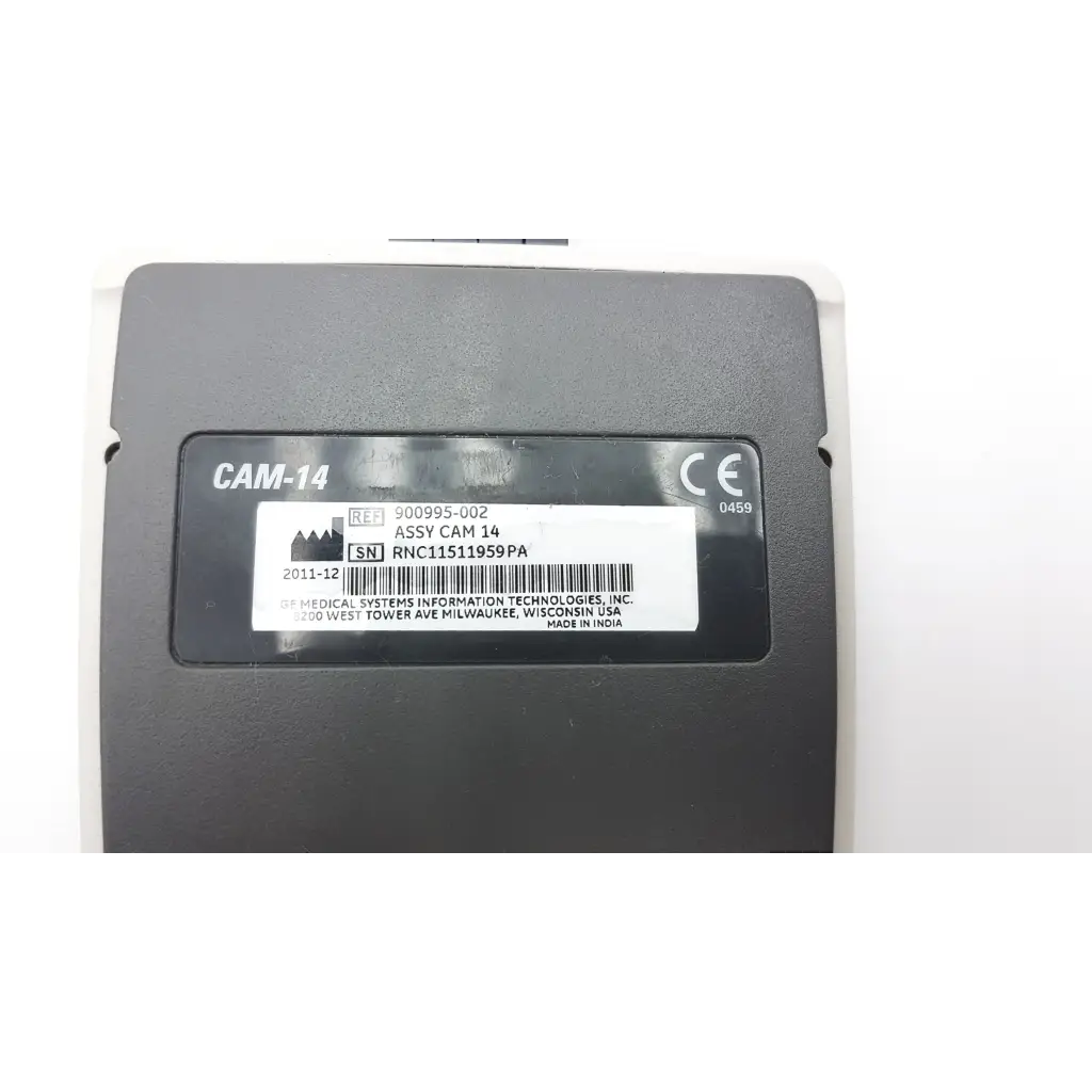 Black plastic GE Medical System CAM-14 ecg acquisition module with white label showing serial number and manufacturer details