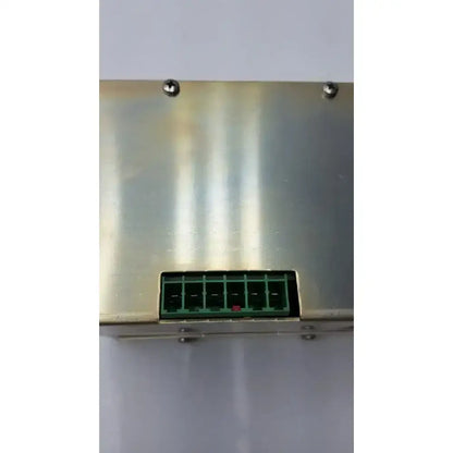 Green plastic connector with six slots mounted on brushed stainless steel panel on back of GE medical vivid 7 pro power supply