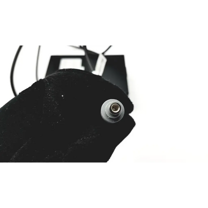 Black velvet glove holding a silver cylindrical connector for ge transport display power supply 2012183-004