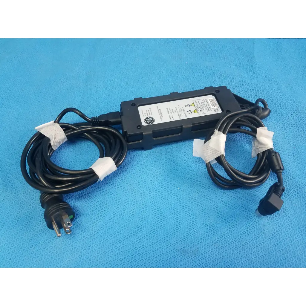 Black ge twadp100 adapter power supply with coiled black cords and white tape for vivid i vivid q ultrasound use