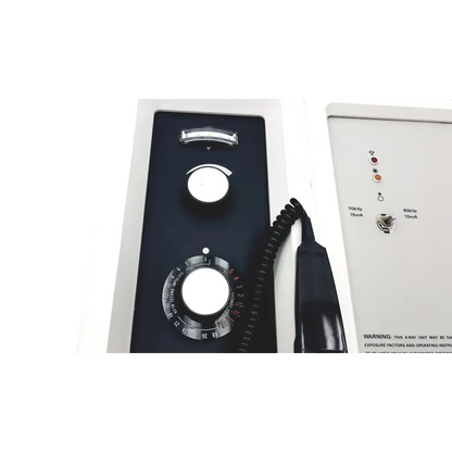 Black control panel with two white-marked rotary dials and coiled cable on gendex gx 900 wall mount dental xray