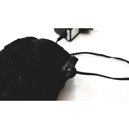 Black plush hat with a small camera and cable shown with genuine jentec technology switching power supply adapter 5v 3a