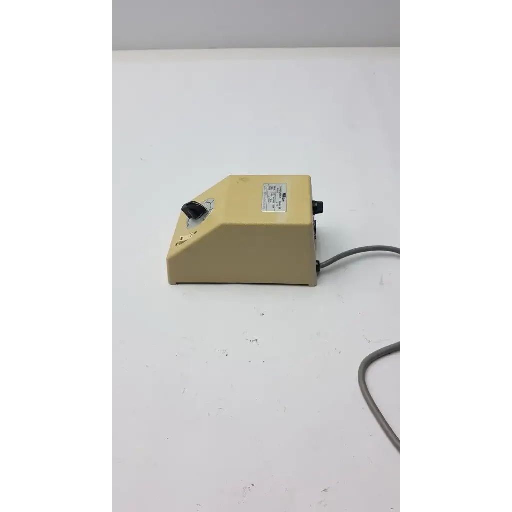 Beige plastic laboratory mixer with black rotary knob and power cord for genuine Nikon transformer xn made in Japan